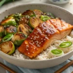 Teriyaki salmon bowl with crispy brussels sprouts, jasmine rice, and sesame seeds