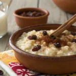 Traditional Mexican arroz con leche in a rustic bowl with cinnamon and raisins