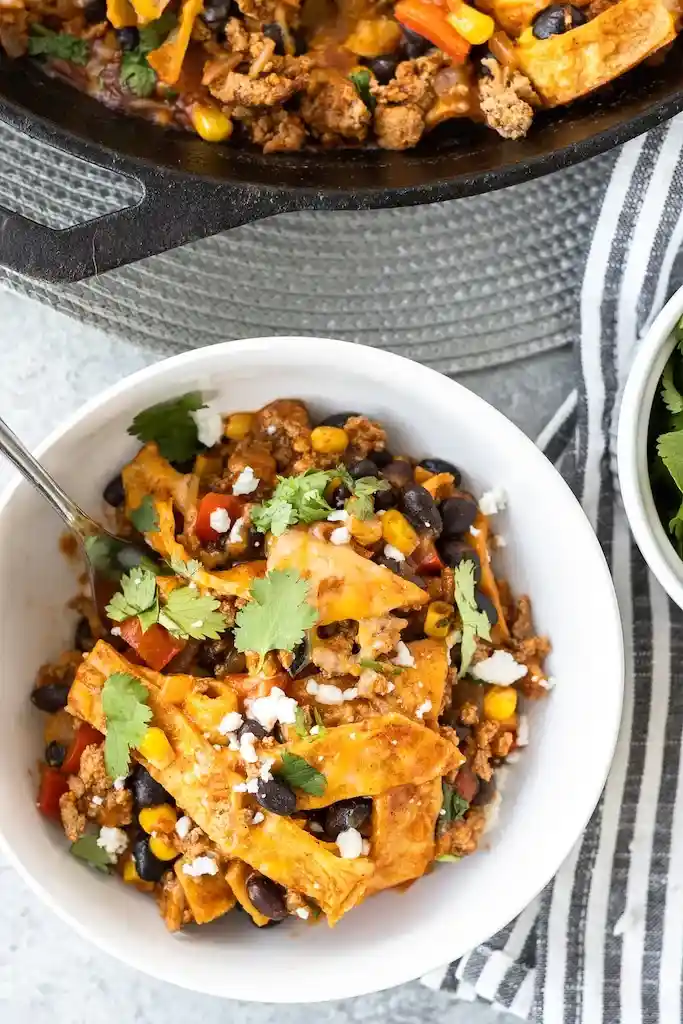 Bowls with different substitutions for enchilada skillet: lentils, roasted veggies, chicken