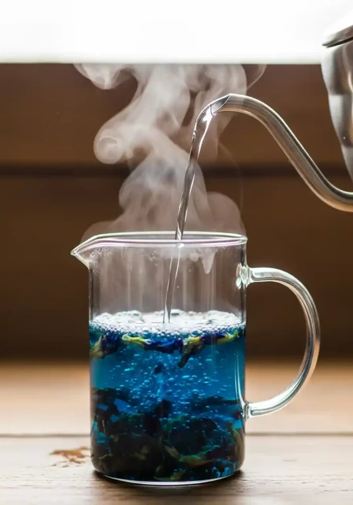 Close-up of deep blue Butterfly Pea Flower Tea steeping in a clear glass vessel.