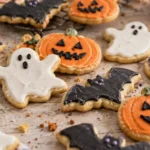 A batch of freshly baked Halloween sugar cookies in various spooky shapes