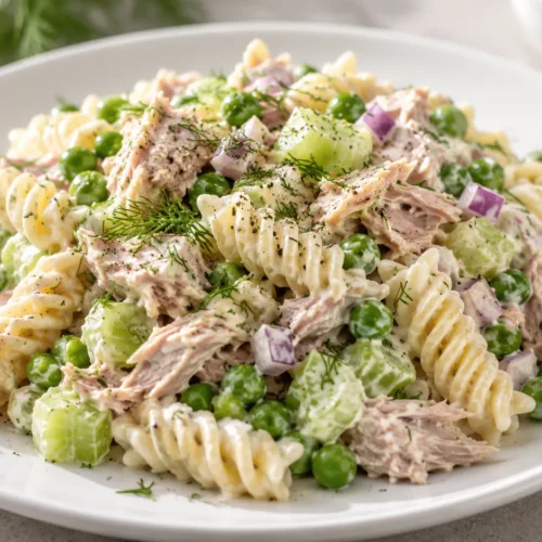 A freshly prepared tuna pasta salad on a white plate